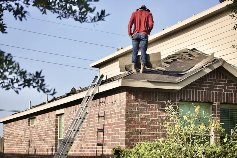 Professional roofer working on a residential roof in Lionspaw